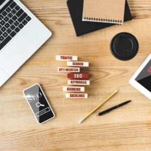 top view of wooden rectangles with illustration of concept words of seo, digital devices, notebooks,